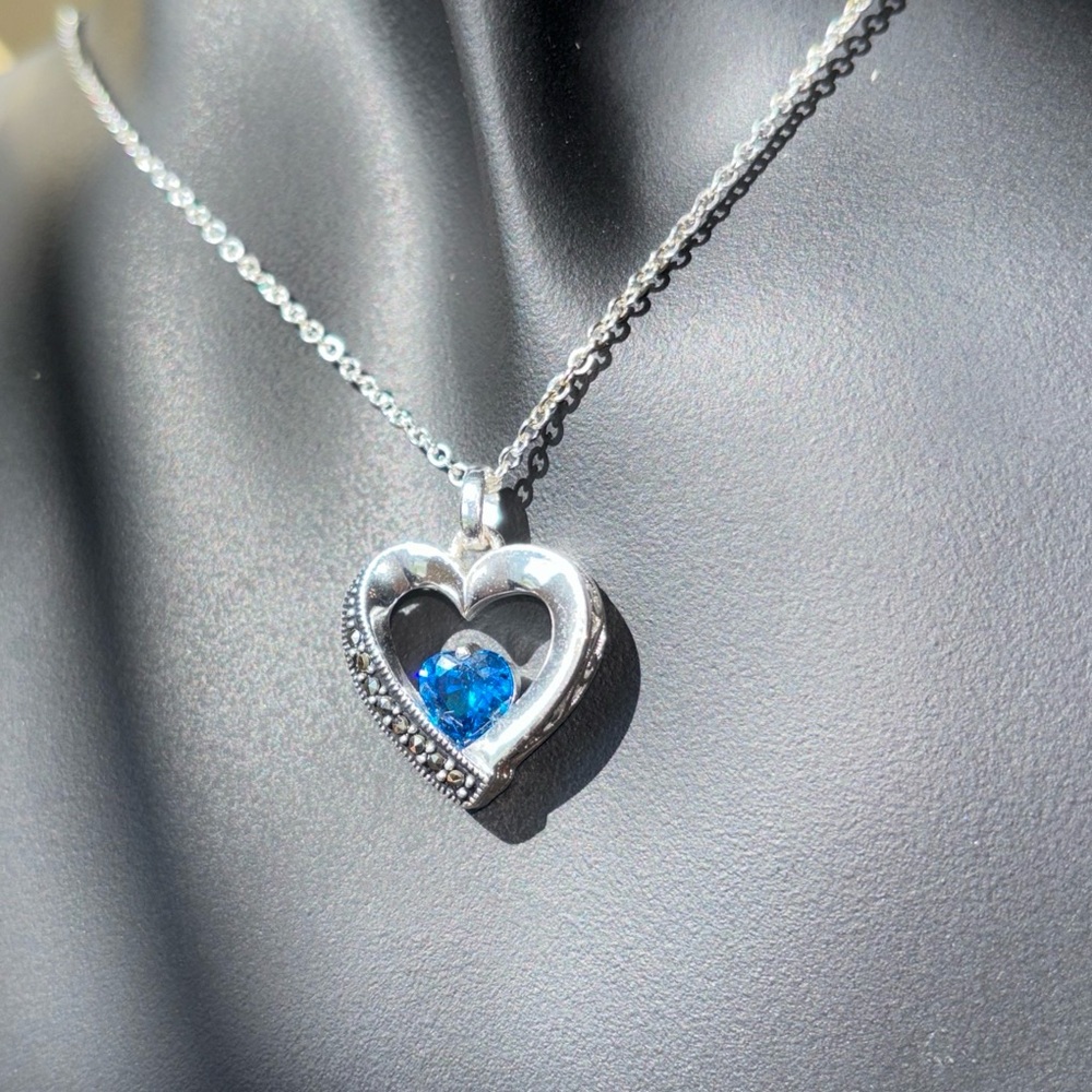 Sterling silver necklace with heart pendant with blue topaz